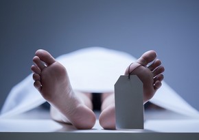 A man in dead body bag rises in a morgue