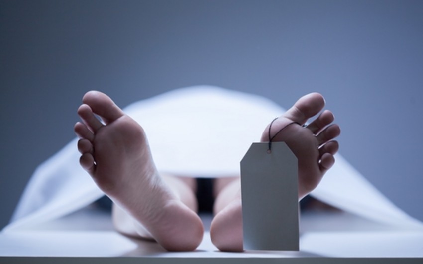 A man in dead body bag rises in a morgue