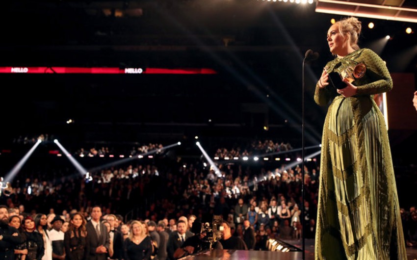 Singer Adele grabs Grammys for best song and best album