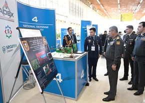 Zakir Hasanov views booth of National Defense University at ADEX exhibition