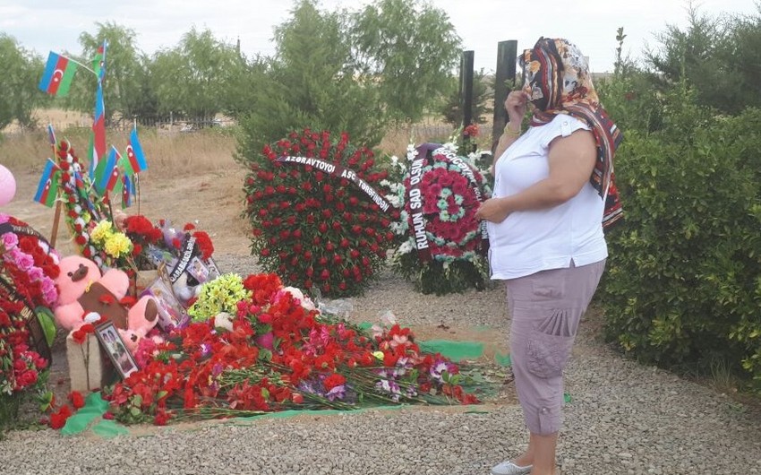 Oksana Altunyan living in Moscow visits graves of killed Azerbaijani baby girl Zahra and her grandmother