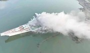 China investigating cause of fire on retired aircraft carrier