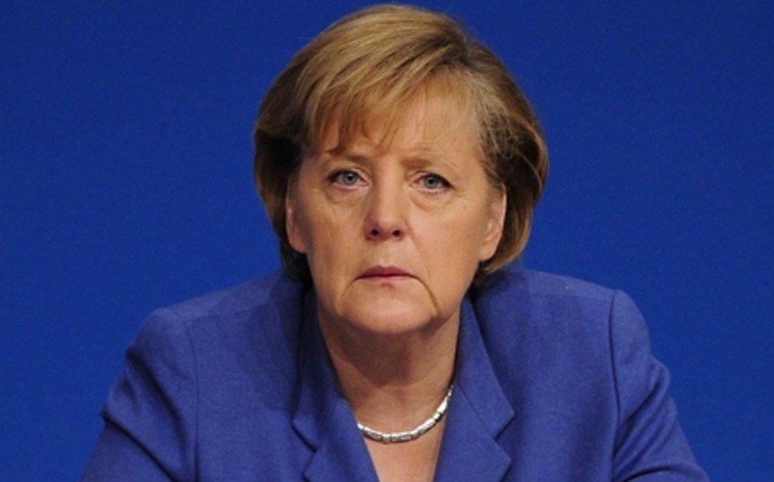 Angela Merkel booed by German protesters at refugee centre